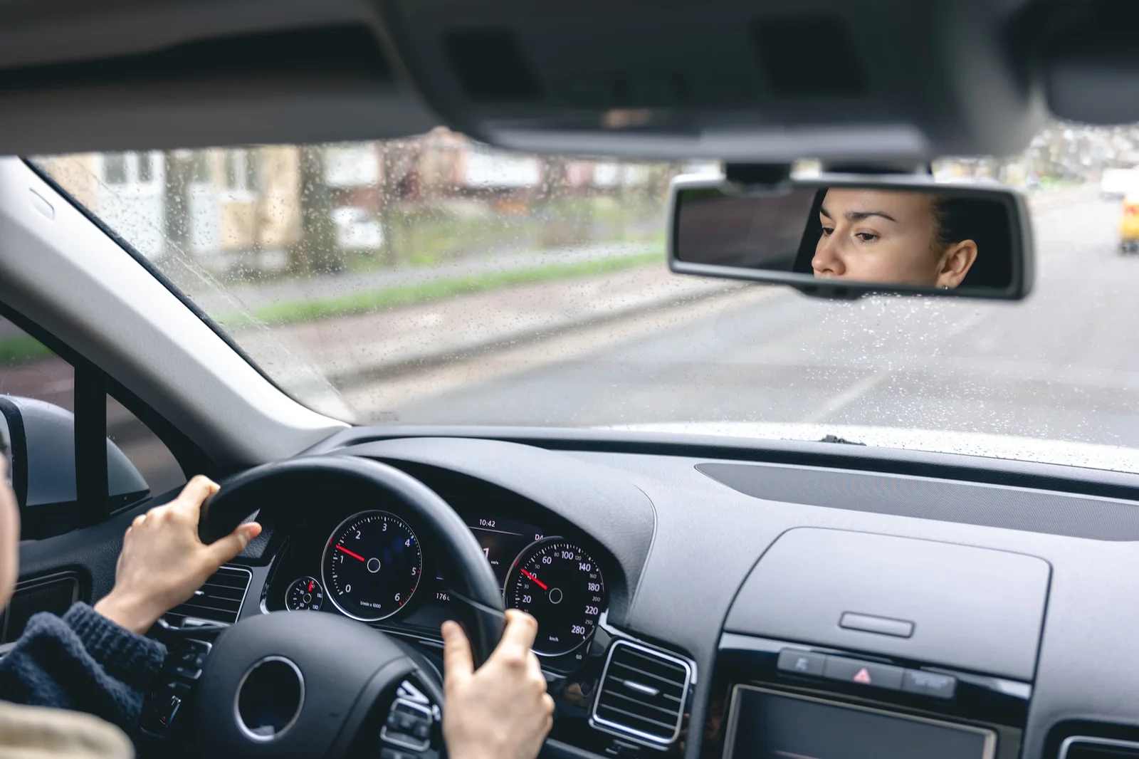 woman-drive-a-car-reflects-in-back-view-mirror-
